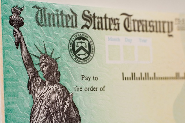 A blank US goverment check with selective focus on the statue of liberty